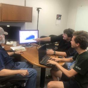 Dakotah Jefferson, Dr. Djalali, and Noah Smith discussing results during a weekly meeting.