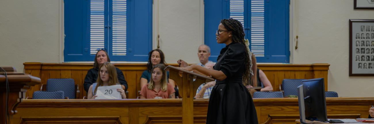 Summer law and trial institute courtroom scene, with a high school student addressing the court.