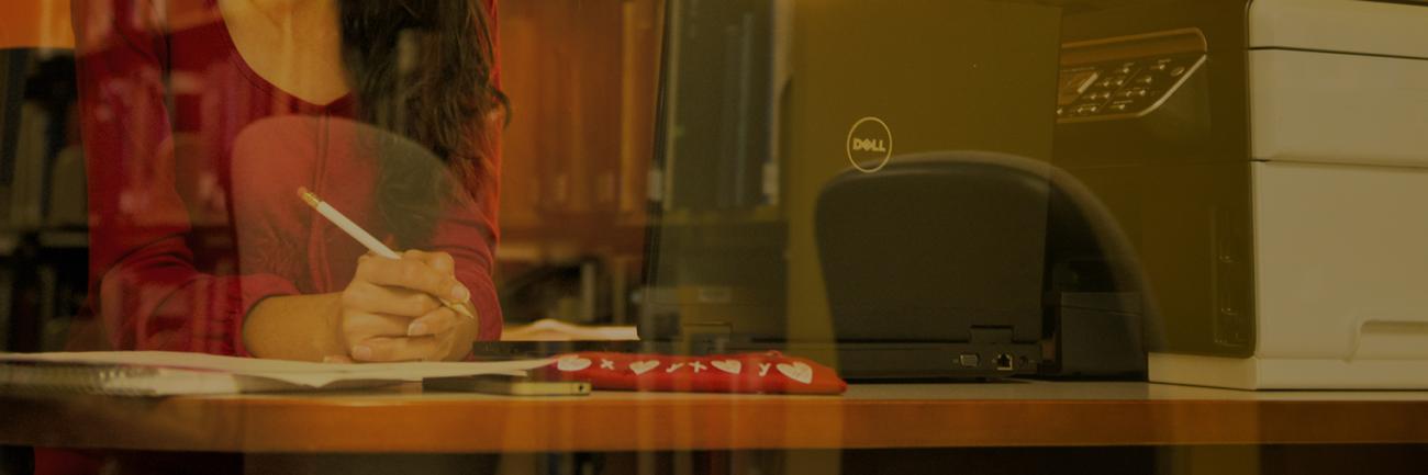 A student on a laptop in the library