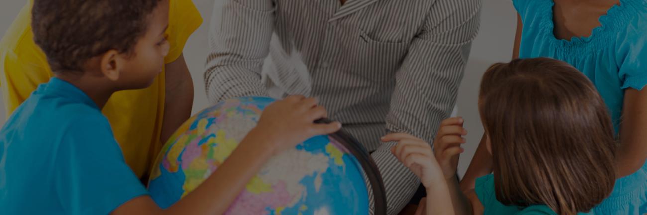 photo of children and globe