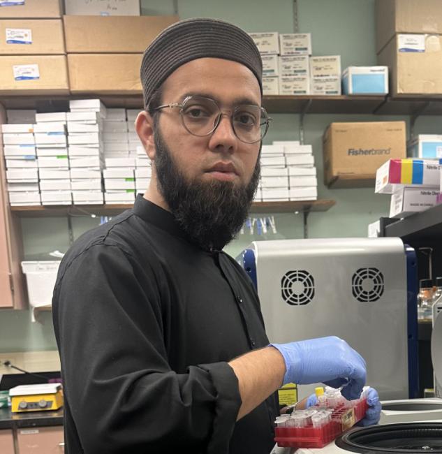 A headshot of Fitrat Ullah working in a lab