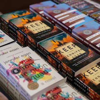 Table full of Jennifer Egan's books when she spoke on campus