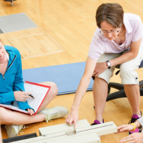 Exercise Physiology Instructor and Students sitting in a circle around equipment