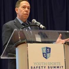 Timothy Neal speaking at podium
