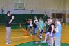 Gym teacher speaking with children.