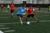 Soccer players running for the ball