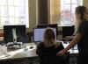 Center for Technology and Online Programs Computer Lab Graduate Assistant helping a student