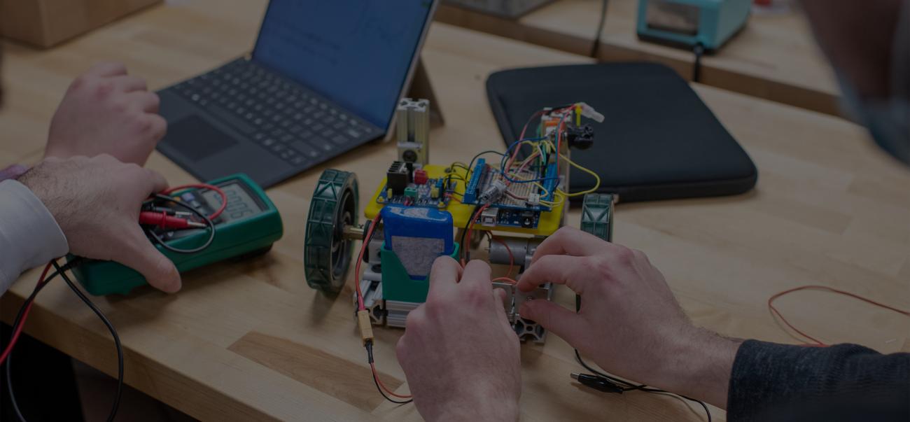 Students work on a robot together.