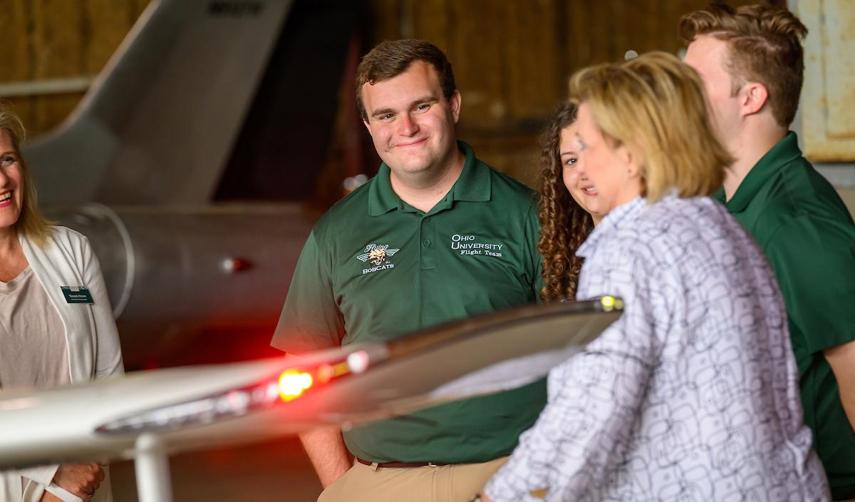 President Lori Stewart Gonzalez with aviation students at the Bush Airport as new planes arrive.