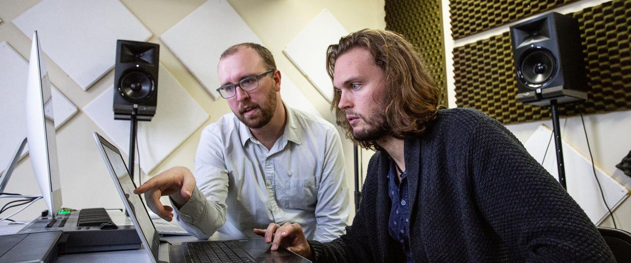 Faculty and student at a music workstation