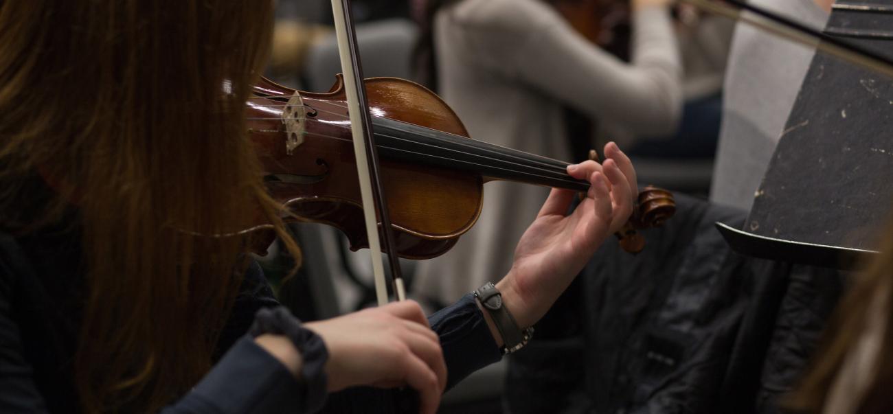 Student playing at orchestra practice.