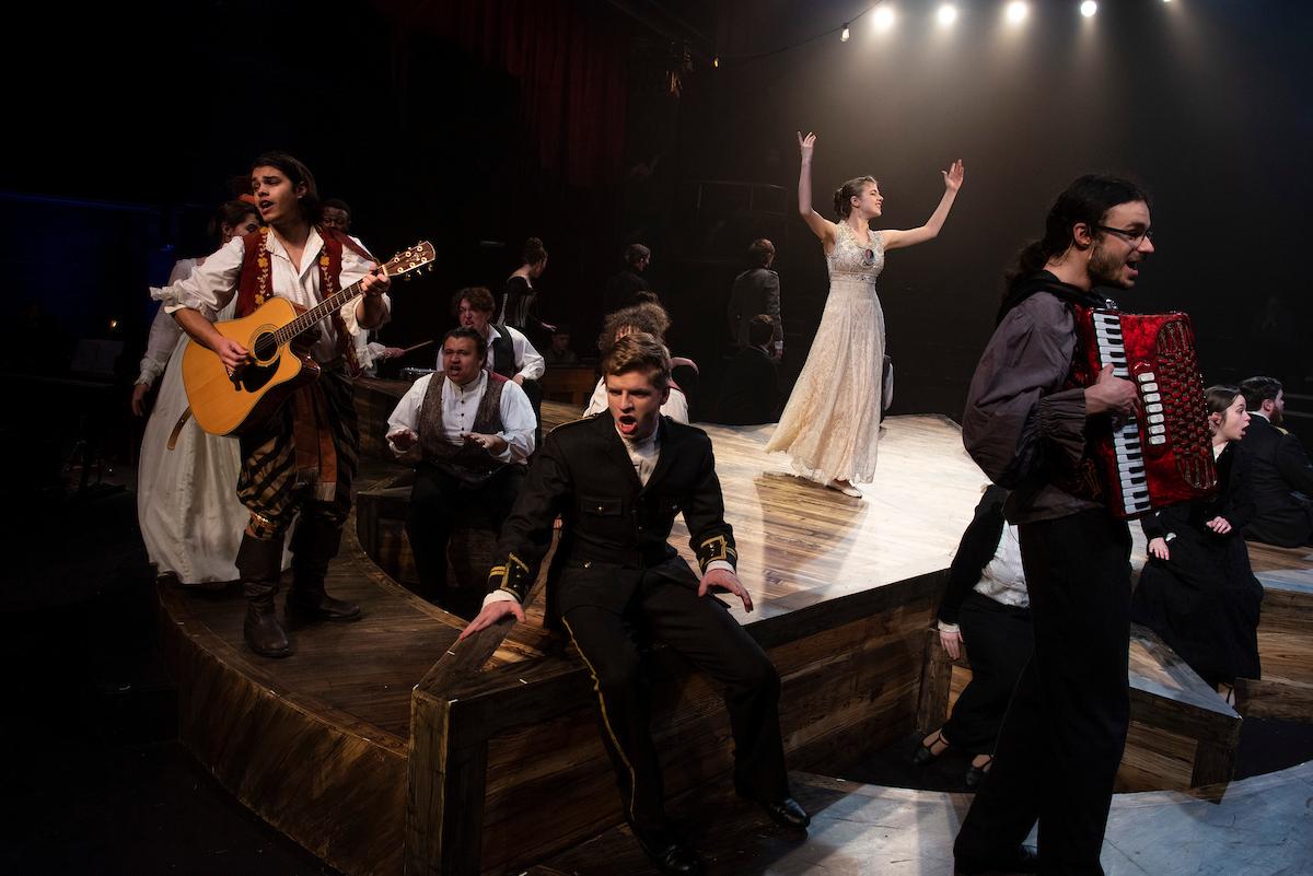 Students act on stage during a performance