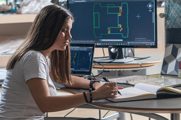 An OHIO interior architecture student working on a drawing