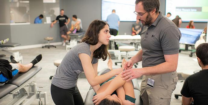 Student, Instructor, and patient in omm lab