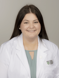 head shot of student wearing their white coat