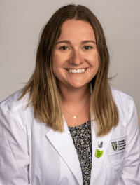 Head shot of student in their white coat