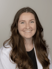 Head shot of student in their white coat