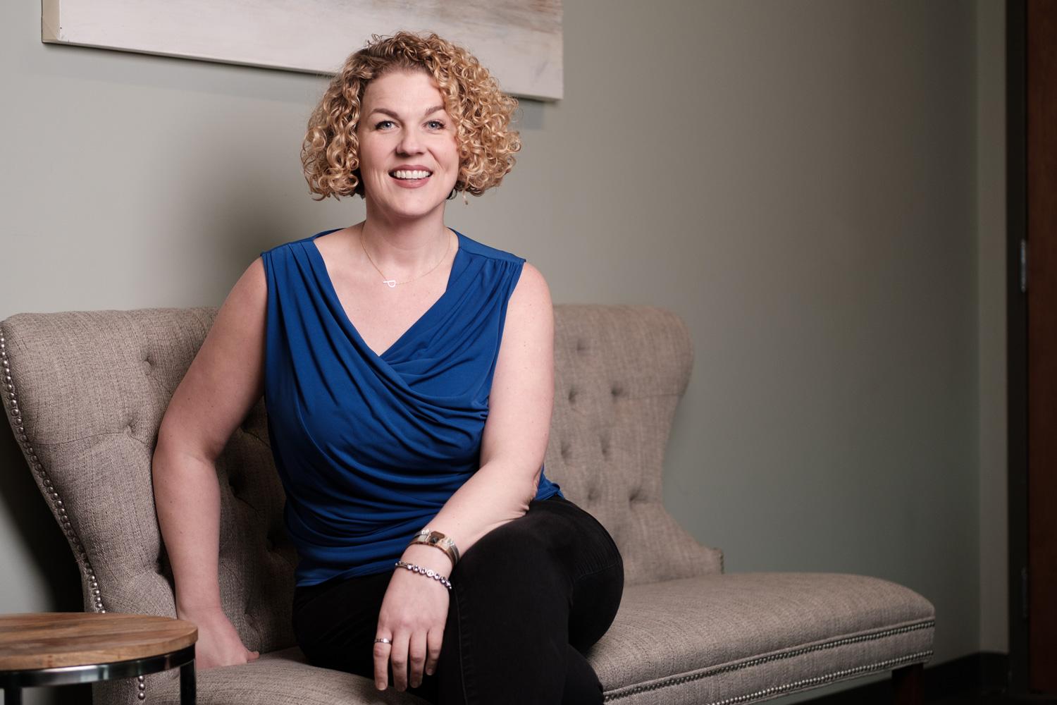 Paige Gutheil sitting on sofa