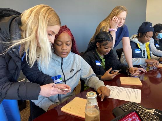 Four Aspiring Doctors students get instructions on how to suture