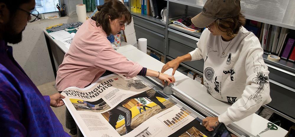 Students printing a large piece of paper