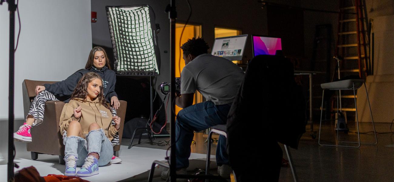 A student photographer takes photos in the studio for a project. Behind the scenes photo taken by OHIO student Shamar Semple.