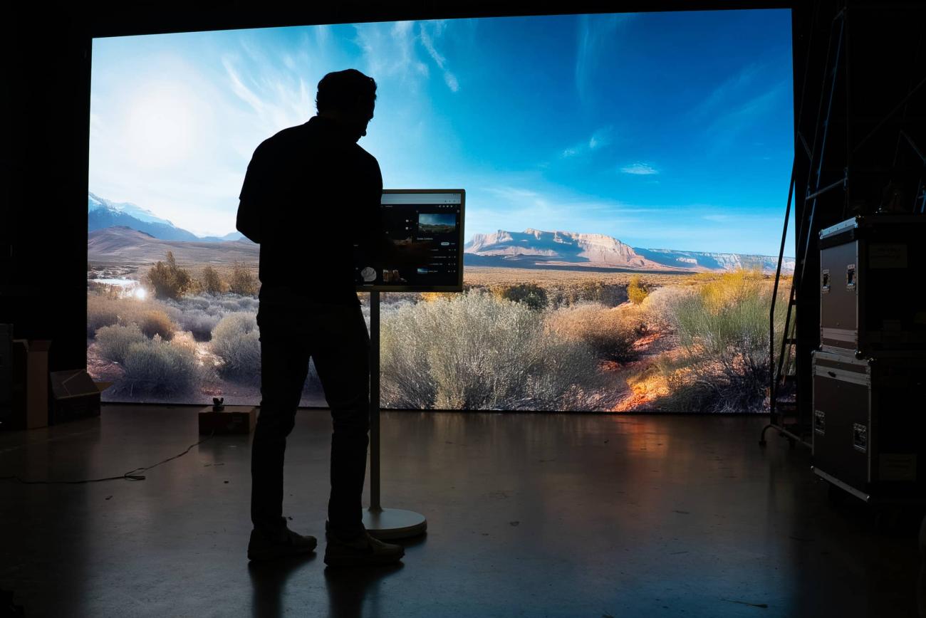 Student stands in front of an LED Wall while creating a video