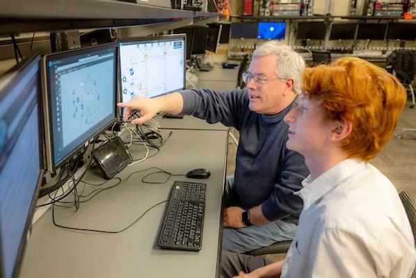 Student and faculty working in the advanced networking lab.