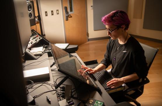 woman using a large computer in the studio