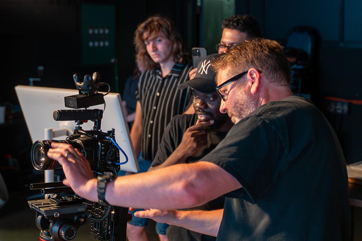 Professors and students work together using video equipment in a video studio