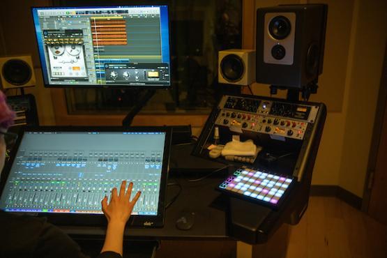 a hand is using a mixing computer tool