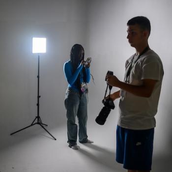 Two visual communications students work in a photography studio