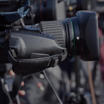 A camera lined up at a news conference