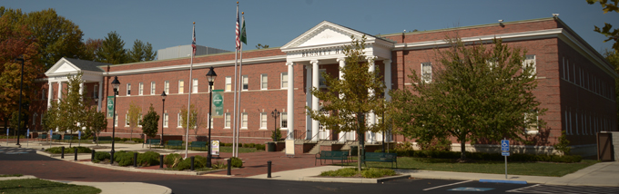 A brick building with white trim and columns