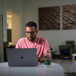 Man looking at his computer in a classroom