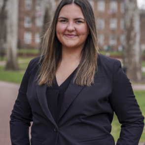 Headshot of Kali Osborne in dark suit 
