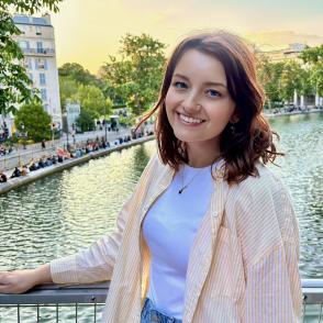 A photo of a woman in front of a river