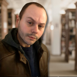 Photo of Eric Brown, with tilted head and raised eyebrow