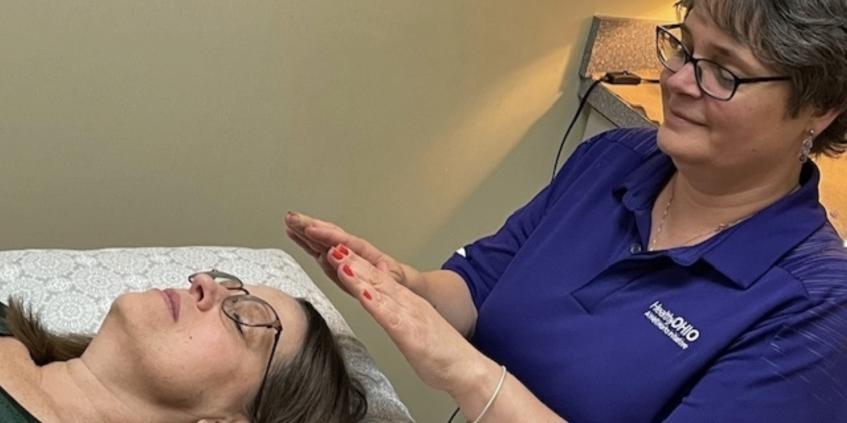 Practitioner performing Reiki on a client