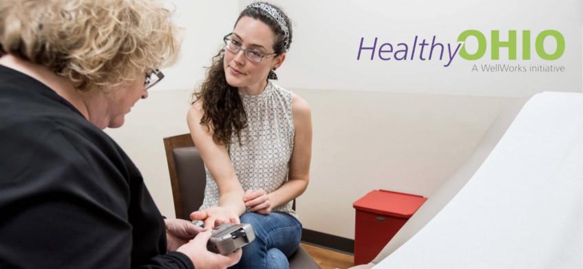 Person getting a health screening from a nurse.