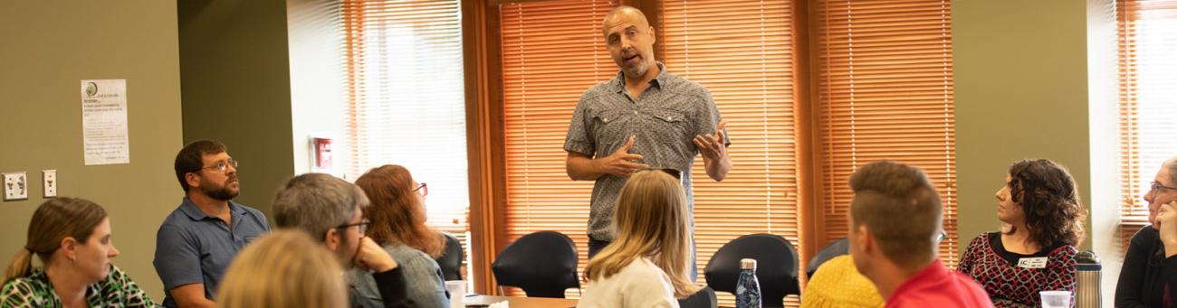 entrepreneur speaks to a group gathered at an Innovation Center networking event