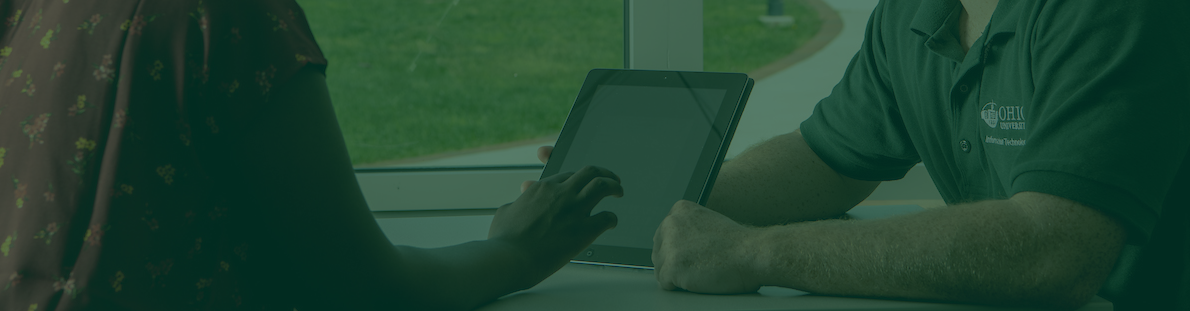 Two students look at a tablet.