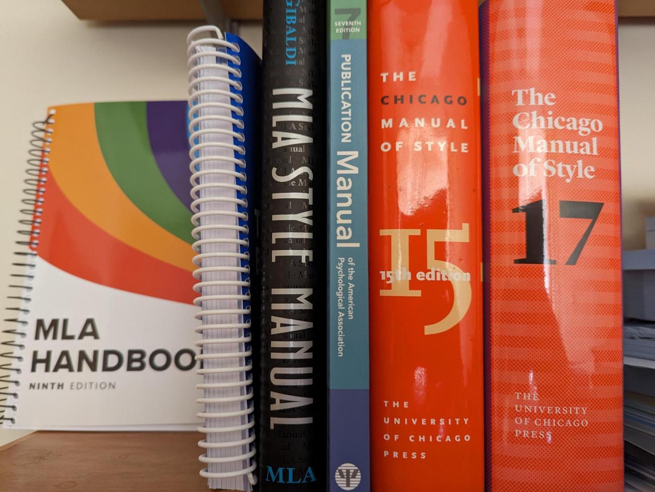 A small stack of books on a bookshelf