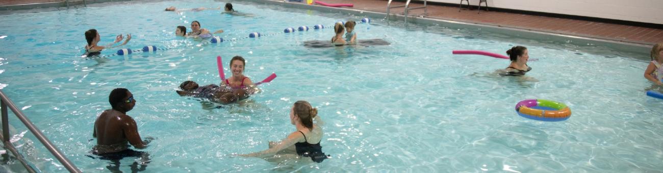 Many people playing in the pool at the Aquatic Center
