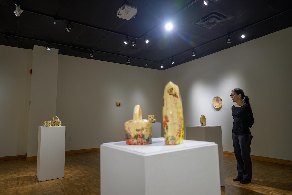 woman viewing pottery