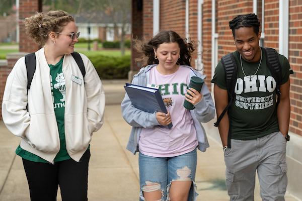 three students walking outdoors