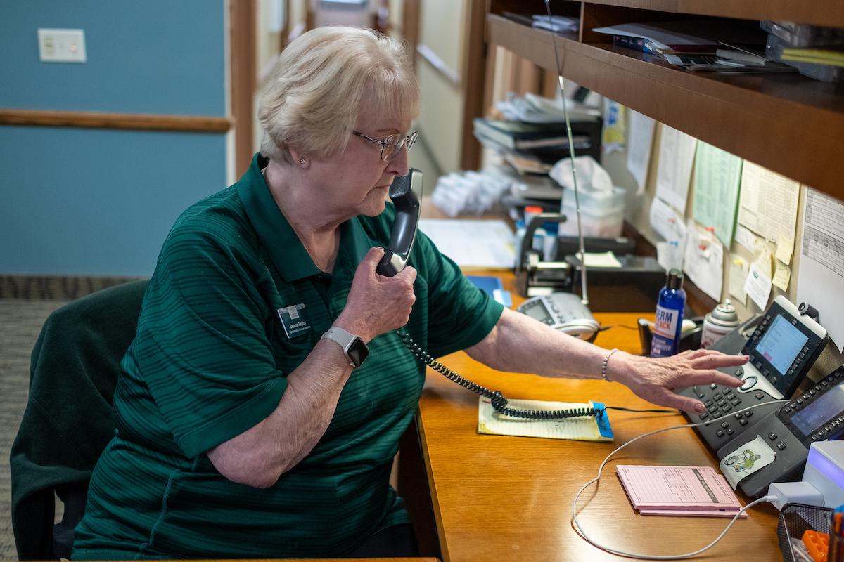 Woman answering phone at front desk