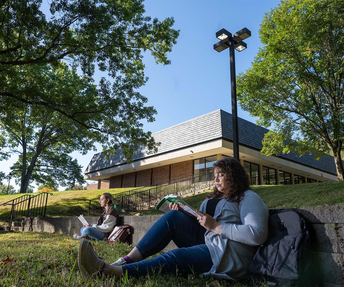 Two students study while sitting in the shade outside at the Chillicothe campus.