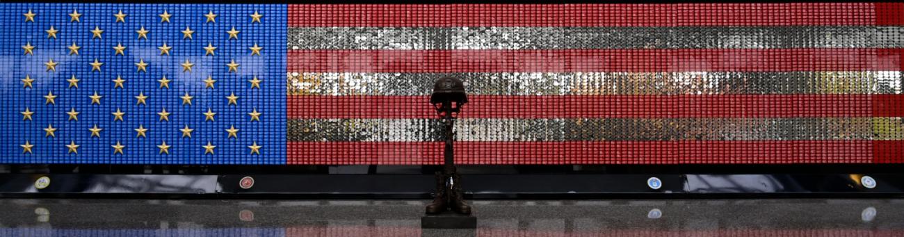 VUA Memorial displaying flag design and bronze statue of boots, rifle, and helmet representing fallen soldiers