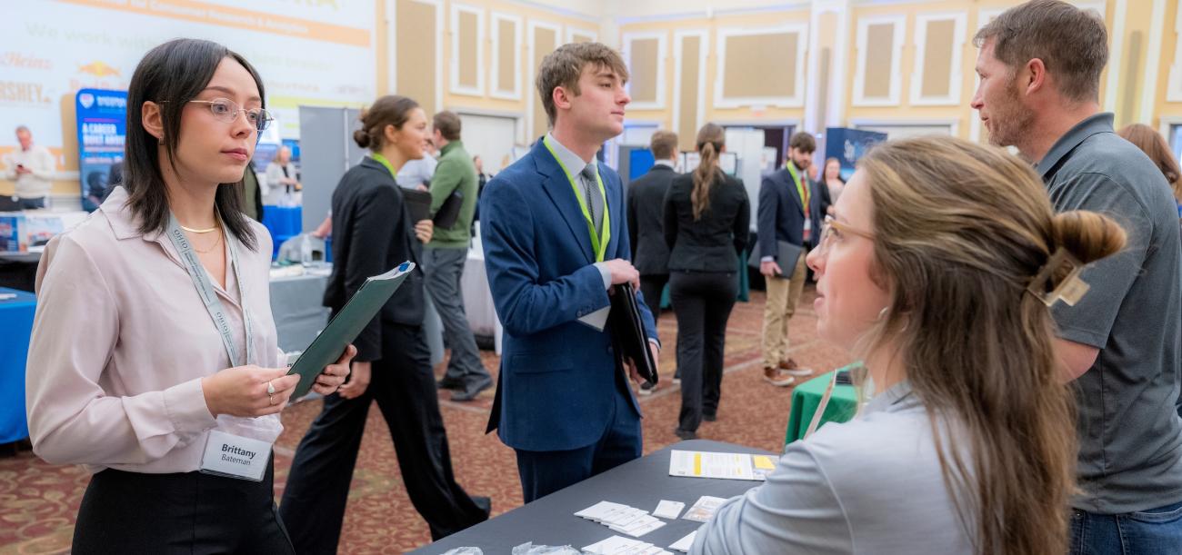 Students speaking with employers at job fair