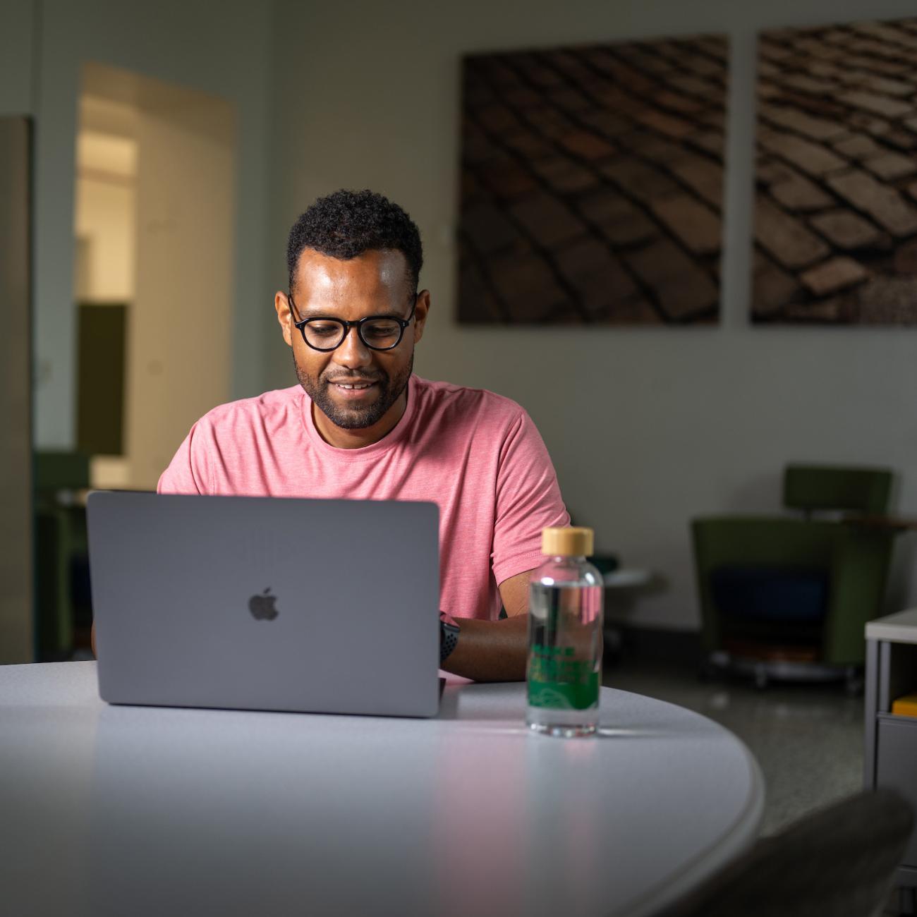 A student works at their laptop.
